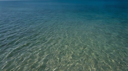 Obraz premium Blue turquoise ocean water on a sunny and beautfiul summer day, with a sandy ocean floor