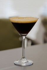Close-up of an espresso martini cocktail in a martini glass.