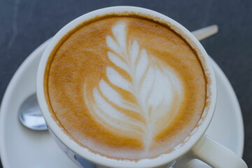 Cup of latte with leaf latte art