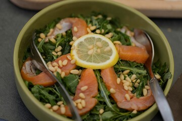 Fresh salmon salad with pine nuts and lemon
