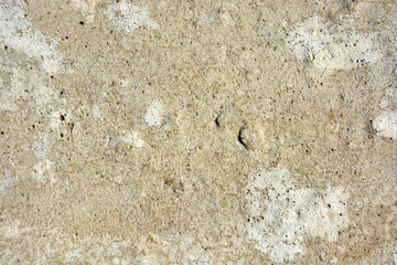 Building materials, gray original cement, light brown background with small irregularities and hollows.