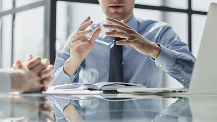 Two business men sit at desk discuss project details sales manager makes commercial offer to...