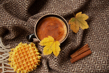 Cozy autumn coffee with leaves and a blanket