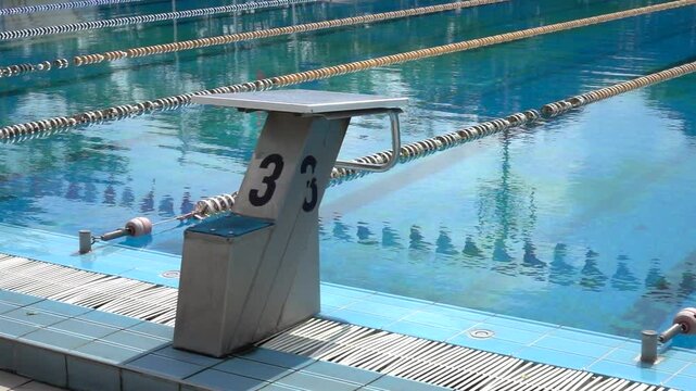 Empty starting block at a swimming pool. Training arena, platform for jumping