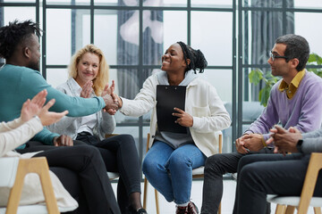 conducts business training with a group of young people.