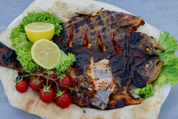 Grilled fish with lemon and cherry tomatoes