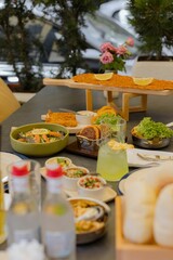 Outdoor dining with a variety of dishes and drinks.