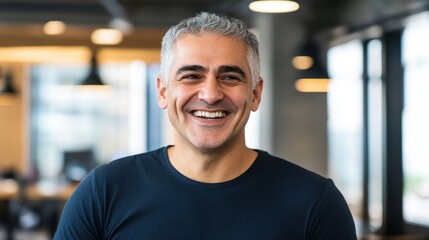 Fototapeta premium Confident Mature Man Smiling in Modern Office Environment