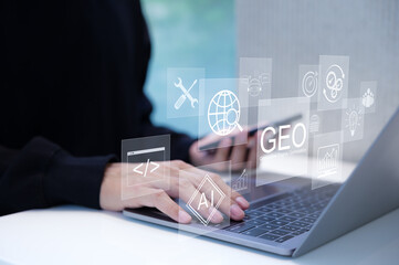 GEO Concept. Generative Engine Optimization for Online Marketing Strategy, Hands typing on laptop...