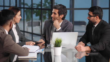 Teamwork - discussion in the office. young and successful