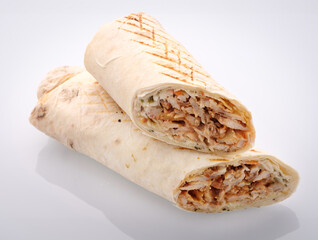 Savory grilled chicken wrap served on a pristine white surface, showcasing fresh ingredients and appetizing presentation