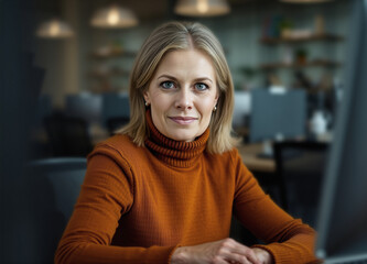 recruitment for a role, seasonal modern attire and turtleneck, older data entry clerk who is managing the role, office chair, reception desk, dark orange dark brown, business portrait