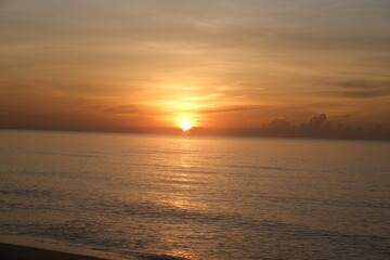 The sun rises at the sea in the morning.