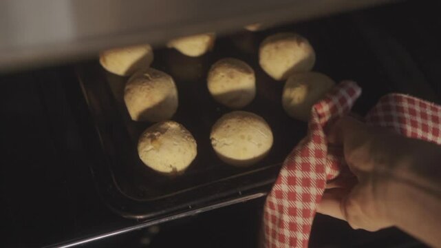Mouth watering chipa bread rolls baking in the oven, capturing homemade south american cuisine. Fresh dough and artisanal techniques create delicious comfort food footage