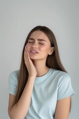 Fototapeta premium A woman is experiencing tooth pain discomfort expression healthcare.