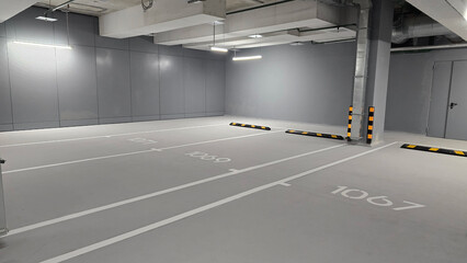 Concrete empty car parking, gray room of multi level parking with spaces for car, parking in building for safe storage of personal vehicle © malazoniia