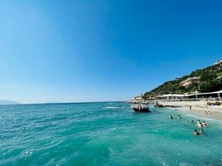 Rocky beach and crystal turquoise water of Ionian Sea in Albania.