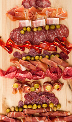 Christmas tree made of sausage on a background of a wooden wall