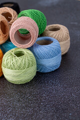 Multicolor yarn for knitting, knitting needles and scissors. Home storage concept and hobby.Raffia is an organic, ecological, wood fiber that is easy to crochet.