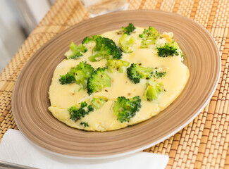 Wholesome breakfast. omelet with broccoli on brown plate
