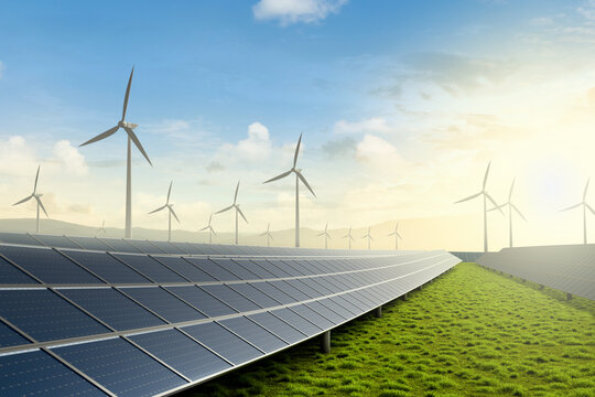 Solar farm and wind turbine on green fields with beautiful sunset background.