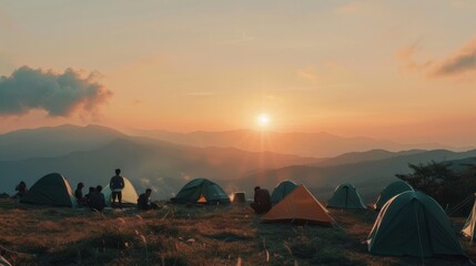 Campers with pitched tents enjoy a scenic mountain sunrise, with warm hues illuminating the serene landscape, creating a tranquil and outdoor adventure vibe.