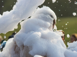 A man is covered in foam and is surrounded by people