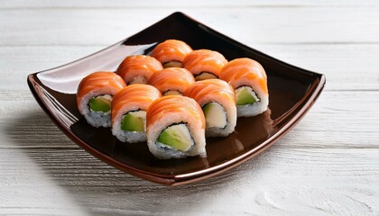 Salmon and avocado sushi rolls on white wooden background