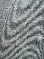 Black and white, grey denim jeans textile for any background. Faded black jeans. Denim fabric. Canvas denim jeans texture. 