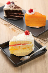 Colorful Slices of Cake on Black Plate
