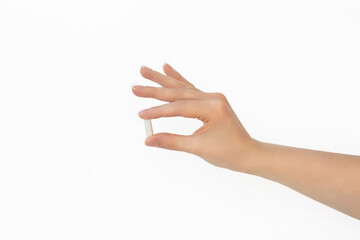 White pill in female hand on white background, Taking Your Medication