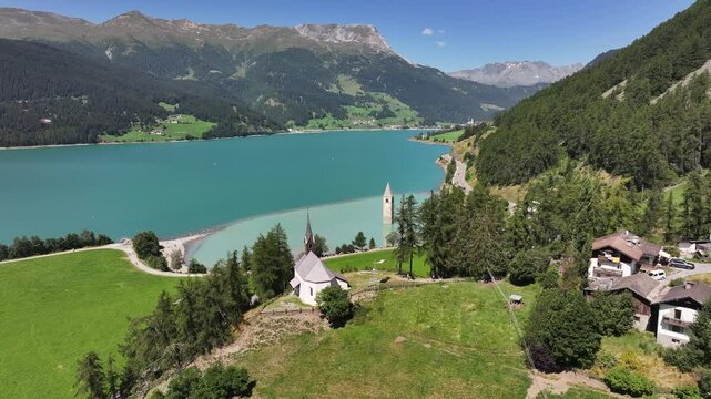 Famous flooded - in 1950- bell tower from the 14th century of Graun in the Reschen Lake in South Tyrol, Italy