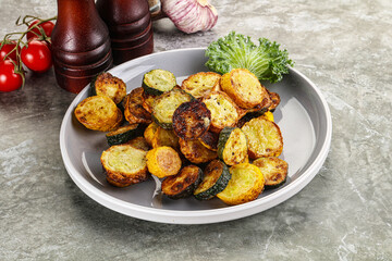 Roasted young zucchini in the plate