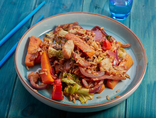 Healthy fish stir fry with vegetables and rice.