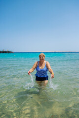 Woman relaxing on the beach in the sea. Selective focus.