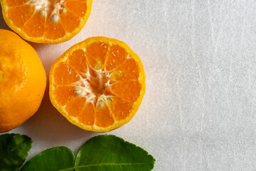 Orange leaves and fruit slice on white background
