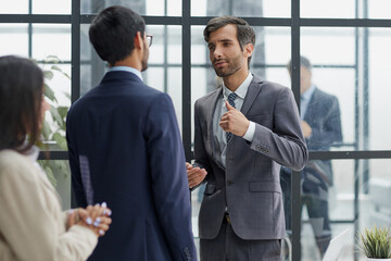 Fototapeta premium Successful team of young perspective businesspeople in office