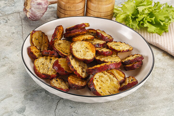 Baked red batat slices with herbs