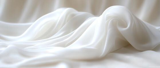 Obraz premium Elegant white fabric drapes gracefully, creating soft waves and smooth textures, perfect for backgrounds and creative designs.