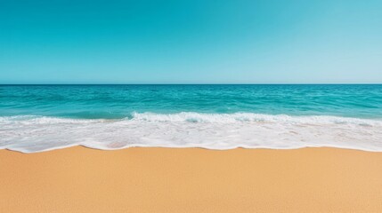 Fototapeta premium Scenic beach view with turquoise ocean and soft sand under clear blue sky.