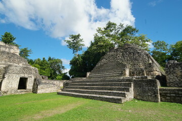 Exploring the ancient ruins of Caracol in Belize, surrounded by lush nature and remarkable architecture