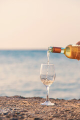Woman with a glass of wine at the sea. Selective focus.