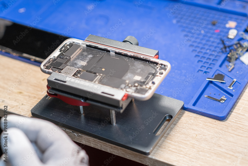 Poster a technician carefully works on a smartphone to replace its battery in a dedicated repair space fill