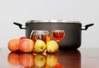 Glass Of Fruit Cider with Some Fruits and Stockpot. Bright Background