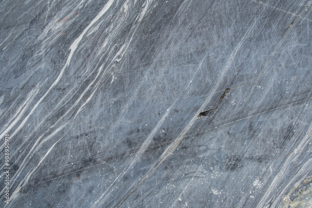 Poster the smooth surface of gray marble features intricate white veining, highlighting its unique patterns