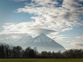 Snow-capped mountain landscape under partly cloudy sky