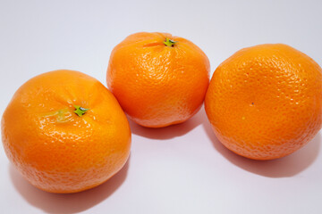 Tangerines and oranges in gray with a ripe fruit. new year's orange concept. a colorful of tangerines and other fruits of the new year. a tangerine on a gray with fruits of the new year lifestyle.