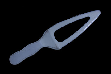 plastic cake knife isolated on black background