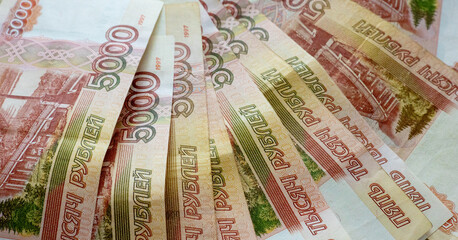 Banknotes of the Russian Federation. Close-up of Russian rubles on a wooden background. Financial concept. Banknotes in denominations of 5000 rubles. Side view