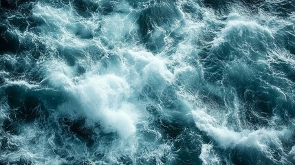 Fototapeta premium An aerial view of churning ocean water with whitecaps and frothy waves